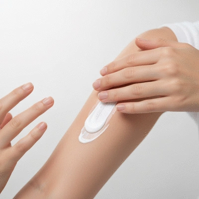Person applying hypoallergenic cream to arm, focus on hands and arm, clean image